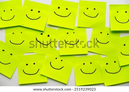 Colored sheets of paper, with smiley faces drawn on them, inclusion, harmony and welcome.