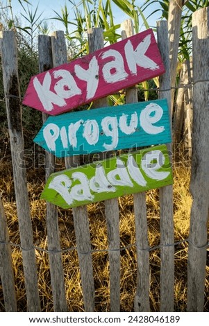 Colored signs on wooden fence in french 