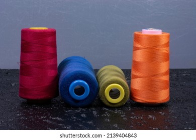 colored spools on black background