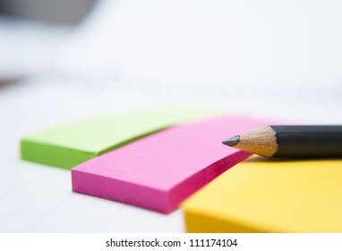 Colored sticky notes and a pencil
