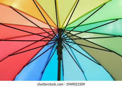 Colored Striped Umbrella Against The Sun Light