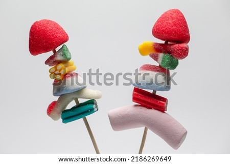 Colored sweets. Sweets with sugar. Baubles stuck on a wooden skewer. Halloween parties. Children's sweets.