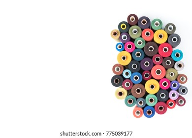Colored thread coils on white background, sewing supplies, text ready, banner, book or magazine cover, textile background