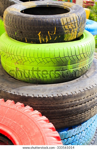 colored\
tires. Stack of colored tires of different\
sizes