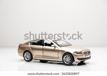 Colored toy car models in scale on a white background