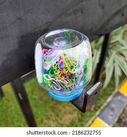 colored triangular paper clip with plastic box