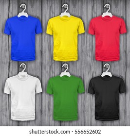 colored t-shirts hanging on a wooden wall - Powered by Shutterstock