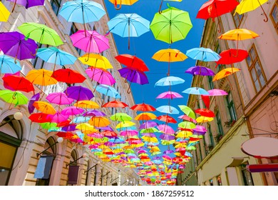 Colored Umbrellas Are Hanging Coloring The Sky Over City Street, Sweep Overhead.