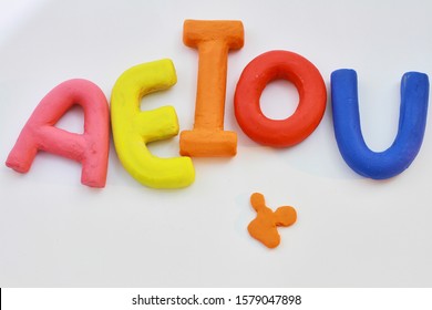 colored vowels in clay with white background - Shutterstock ID 1579047898