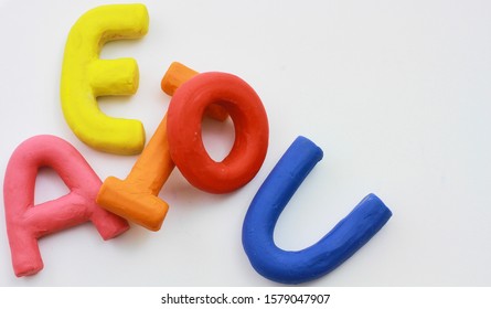 colored vowels in clay with white background - Shutterstock ID 1579047907