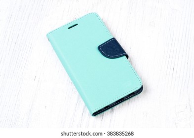 Colored Wallet Case Cover For Mobile Phone On Vintage Wooden Background