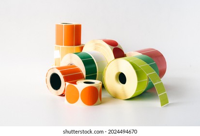 Colored and white rolls of thermal transfer printer labels. Various shapes for direct printing. - Shutterstock ID 2024494670