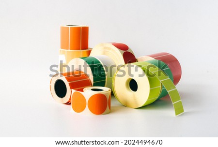 Colored and white rolls of thermal transfer printer labels. Various shapes for direct printing.