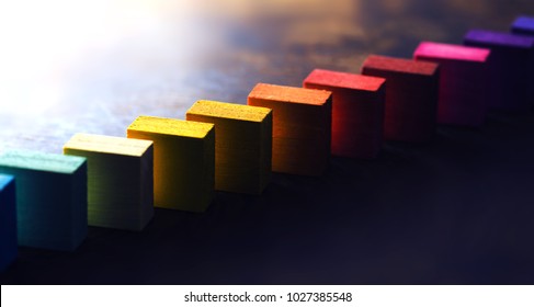 Colored wooden blocks diagonally aligned on old vintage wooden table. For something with concept of variations or diversity. Plenty of copyspace. Shallow depth of field. - Shutterstock ID 1027385548