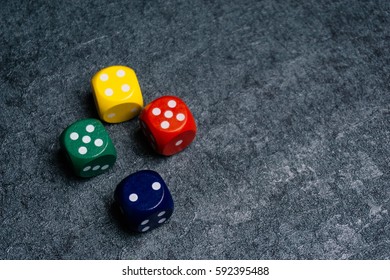 A colored wooden dice isolated over black textured background with copy space for add word text title. - Shutterstock ID 592395488