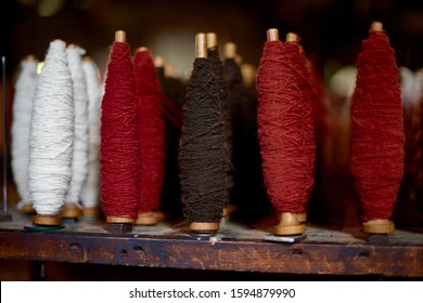 colored woolen threads on an old loom, Traditional Yarn in Canada.