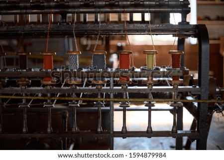 colored woolen threads on an old loom, Traditional Yarn in Canada.