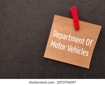 Colores Wooden Clip And Brown Card With Text Department Of Motor Vehicle On Black Background.