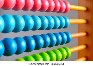 Colorful abacus counting frame calculator beads background. Abacuses have been used in preschools and elementary schools as an aid in teaching the numeral system and arithmetic. No people. Copy space
