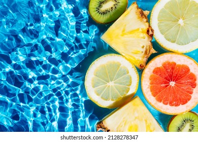 Colorful abstract image fruit citrus lemon, kiwi, orange, pineapple, grapefruit, lemon, pomelo water splashing fresh transparent surface, flecks. Flat lay, top view. Copy space. Summer beach tropical - Powered by Shutterstock