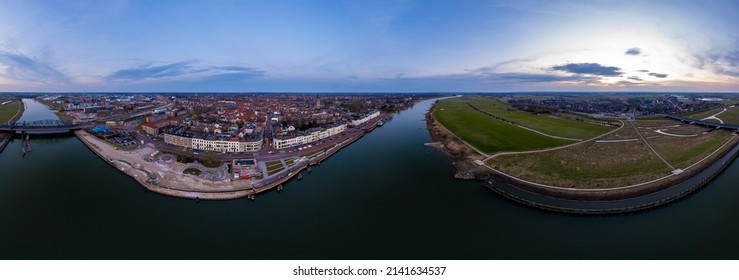 Colorful aerial cityscape of tower town Zutphen ready for use in VR surrounding. 360 degrees panorama of medieval city seen from across the river IJssel passing the white countenance facades. - Shutterstock ID 2141634537