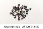 colorful alphabet beads scattered across a white background, perfect for educational or creative projects involving letters and words. 