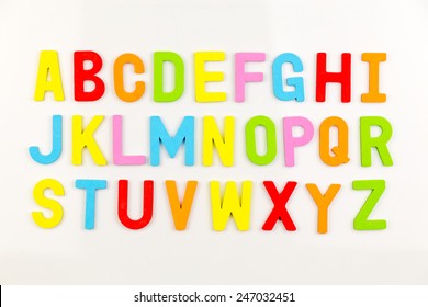 Colorful alphabet magnets on a whiteboard