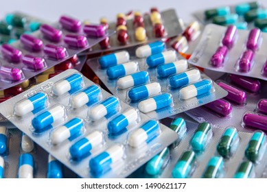 Colorful antibiotic drug capsule pills in blister package.