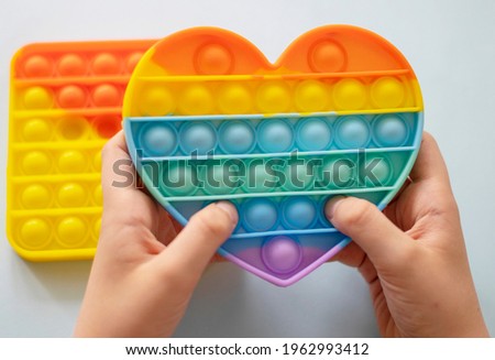 colorful antistress sensory toy fidget push pop it in kid's hands