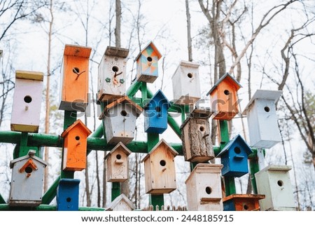 A colorful array of bird houses create a charming urban design fixture, stacked skyhigh. This artful facade is a unique building feature sure to catch the eye of passersby