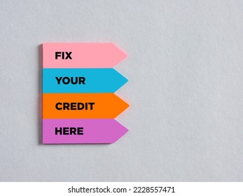 Colorful arrow shaped stickers with the message fix your credit here. Financial loan business concept. - Shutterstock ID 2228557471