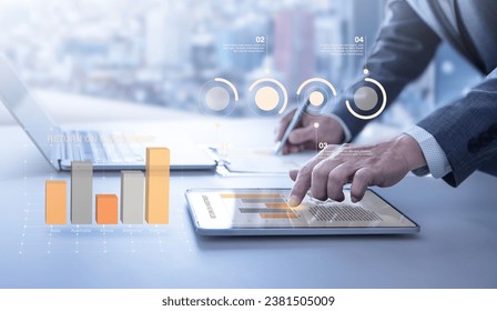 Colorful augmented reality bar graph floating above the desktop surface showing business performance or financial information for investment - Powered by Shutterstock