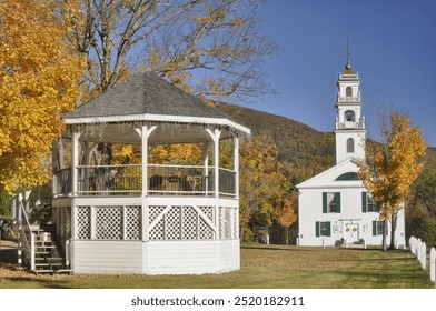 Colorful autumn scene in rural New Hampshire. Charming and picturesque village of Wentworth with town common, gazebo, and historic church with tall white steeple. - Powered by Shutterstock