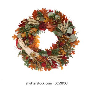 A colorful autumn themed Thanksgiving wreath isolated over white