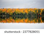 Colorful autumn trees on lake of the Falls in Mercer, Wisconsin, horizontal