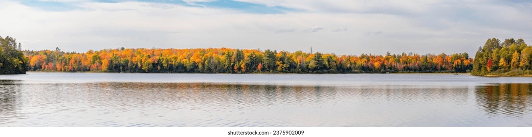 Colorful autumn trees on lake of the Falls in Mercer, Wisconsin, Panorama