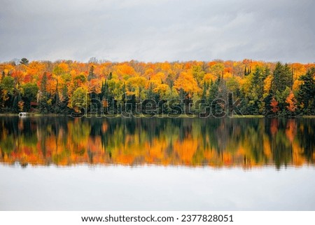 Colorful autumn trees on lake of the Falls in Mercer, Wisconsin, horizontal
