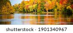 Colorful autumn trees reflecting off of the Wisconsin River in Merrill, Wisconsin, panorama