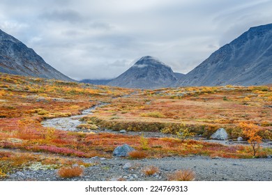 Colorful autumn tundra in front of Malaya Belaya river bend in Hibiny mountains above the Arctic Circle, Russia