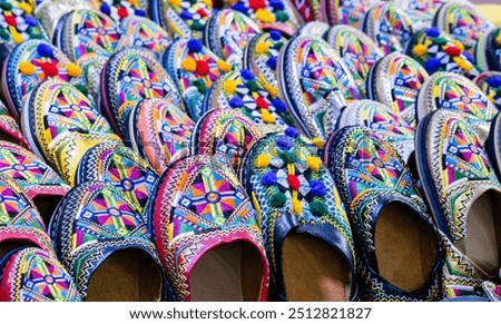 Colorful babouche shoes are traditional Moroccan slippers. Handmade embroidered shoes in oriental style at souk or ethnic market in Agadir, Morocco