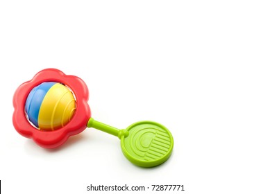 A colorful baby rattle on a white horizontal background