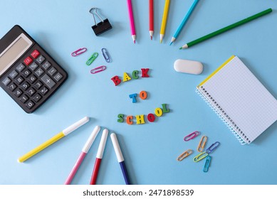 colorful back to school blue background with school supplies and calculator - Powered by Shutterstock