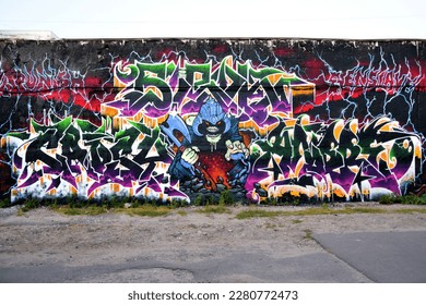 Colorful background of graffiti painting artwork with bright aerosol strips on metal wall. Old school street art piece made with aerosol spray paint cans. Contemporary youth culture backdrop - Shutterstock ID 2280772473