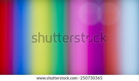 Colorful background pattern and texture with spectral stripes in the colors of the rainbow with a blurred soft muted effect in vertical lines