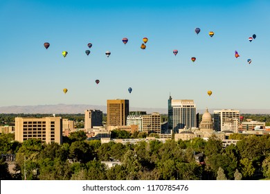 Colorful ballons in a blue sky over the little city of Boise Idaho