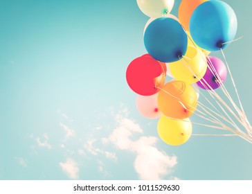 Colorful balloons done with a retro instagram filter effect. Concept of happy birth day in summer and wedding, honeymoon party use for background. Vintage color tone style - Shutterstock ID 1011529630