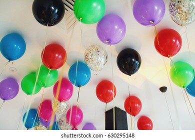 Colorful balloons hang under the white ceiling - Powered by Shutterstock