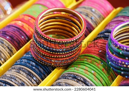 Colorful Bangles display in Shop for women, Metal Bangles Arranged On The Shelf For Sell, Series of bangles. Selective Focus.