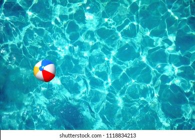 Colorful Beach Ball In Clear Blue Swimming Pool