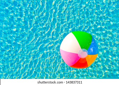 colorful beach ball floating in a pool